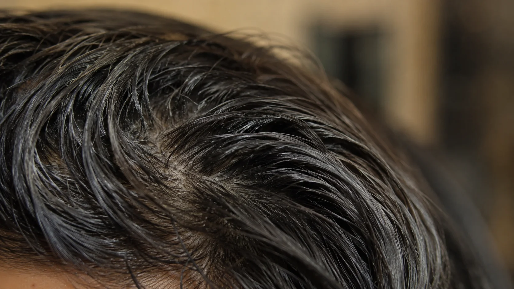Close-up of dull, coated hair weighed down by product buildup
